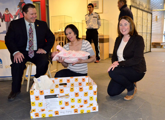 First look at Nunavut's baby box: Emily Shoapik of Pangnirtung places her two-week-old newborn, Rachel Shoapik, into one of the Finnish-style baby boxes, filled with many items for babies and parents, which the Government of Nunavut’s Department of Health will distribute to the moms of newborn infants, as Health Minister George Hickes and Tara MacAskill of Nunavut's health department look on. When Finland began giving out baby boxes in 1939, the country cut its infant mortality rate from 90 per 1,000 to two per 1,000. “I’m thrilled that Nunavut is taking the lead on this baby box initiative—the first publicly funded universal program of its kind in Canada,” Hickes said. Read more later about the baby boxes on Nunatsiaqonline.ca. (PHOTO BY JIM BELL)