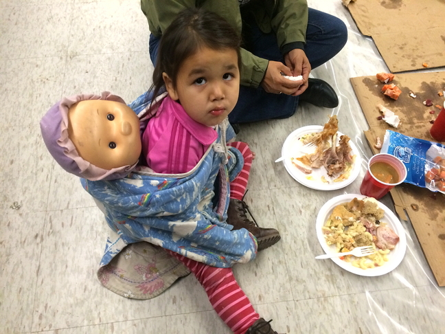 A young Rankin Inlet resident enjoys a plate of food Oct. 19 during a community feast sponsored by Nunavut Tunngavik Inc. which held its annual general meeting in that Kivalliq community this week. There is plenty on the agenda including presentations from regional Inuit organizations and approval of the land claim organization's annual report and budget for next year. Nunavut Tunngavik also presented its 2016