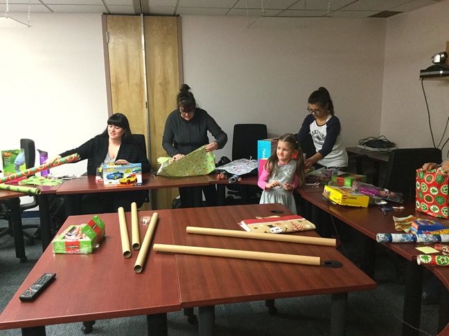 Volunteers Jessica Dewar, Signi Frederickson, Micah Dewar and Sarah Hickes wrap toys which generous Iqalungmiut donated to the Angel Tree Society this year on Dec. 14.
The organization collects new toys every December in Iqaluit to give away to needy families. This year, donors filled the Angel Tree's storage space with toys, which volunteers delivered those toys to families over the weekend. Angel Tree organizers want to thank everyone for their generosity and support. (PHOTO BY EDITH PEDNEAULT)Angel Tree organizers thank everyone for their generosity and support. (PHOTO BY EDITH PEDNEAULT)