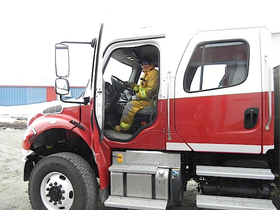 A Puvirnituq firefighter sits in one the Nunavik community's newly-acquired fire trucks in 2012. A report from Quebec's coroner's office recommends more local firefighter training to help prevent fire-related deaths in the region. (FILE PHOTO) 