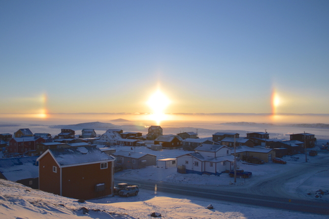 With thirteen days left until the winter solstice marks the shortest day of the year, getting sunlight is at a premium in Nunavut. So all the better for a sun dog to make an appearance and brighten up Iqaluit's lunch hour, Dec. 5. Sun dogs are created on especially cold days, when frozen air crystals in the lower atmosphere align and refract the sun's rays horizontally, creating the illusion of three points of light in the sky. (PHOTO BY STEVE DUCHARME)