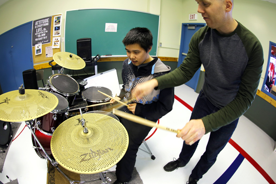 Drum student Willie Nalukturuk, left, gets some help from instructor Tyson Schallmann during a Nunavik Rocks workshop in October 2016. (PHOTO COURTESY OF KRG)