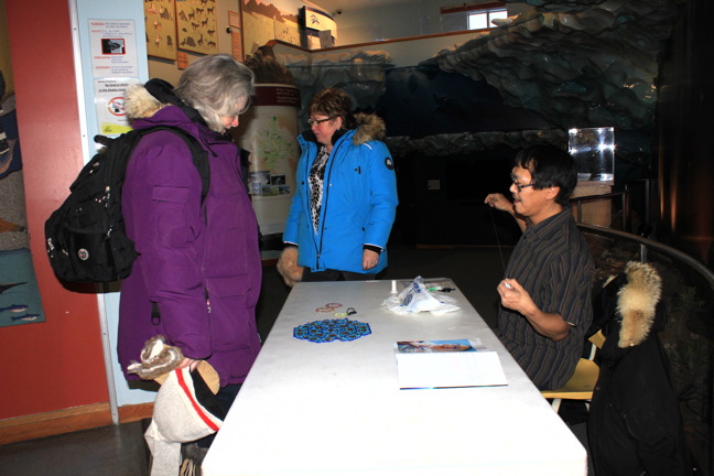 Elisha Kilabuk threads his needle at the Unikkaarvik Visitor Centre Jan. 14 to demonstrate how he does his beadwork. Kilabuk was participating in the Inuit Art Experience, a weekly event offered at the visitor centre on Saturdays from 1 p.m. to 3 p.m. Check out the Unikkaarvik Facebook page for details of upcoming events or call 979-4636. (PHOTO BY LISA GREGOIRE)