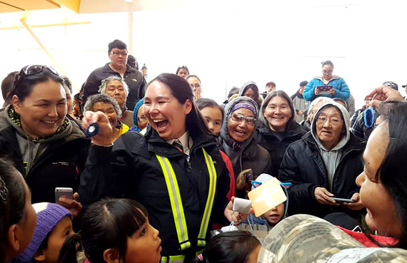 Inukjuak residents give Air Inuit captain Melissa Haney a pair of earrings at the community’s airport terminal last fall at a surprise party for Haney, who became the first Inuk woman to become a Dash 8 captain at the airline. (PHOTO BY CAROLINE OWEETALUKTUK)