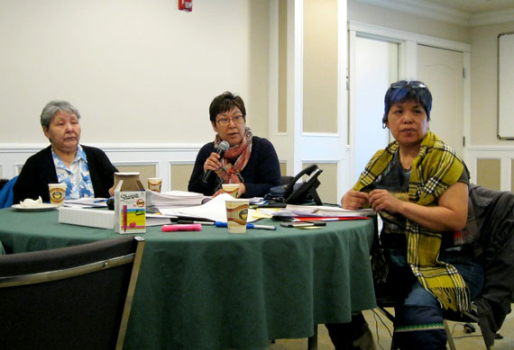 Donna Adams of Rankin Inlet, chair of the Coalition of Nunavut DEAs, puts a question to a presenter at the coalition’s board meeting in Iqaluit March 29 as Nikki Eegeesiak, executive director of the coalition, right, and board member Uluta Ivalutanar of Naujaat listen to the discussion. (PHOTO BY PETER VARGA)