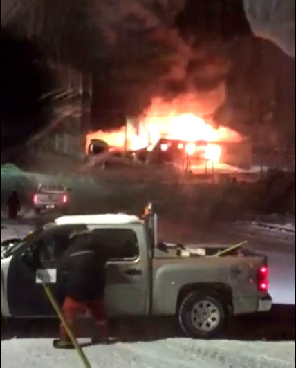 Residents in Kugaaruk watch as Kugaardjuq school burns in the early hours of March 1. Firefighters couldn't put out the fire but contained it enough to spare surrounding infrastructure. (IMAGE COURTESY OF B. TINAK)