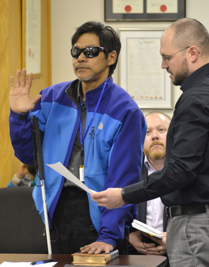 Former, and now newly-elected, Iqaluit Coun. Noah Papatsie swears his oath of office April 25 before a city council meeting.