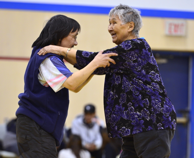 Tommy Dialla takes elder Leah Akpalialuk for a spin at a dance to cap off Hamlet Day in Pangnirtung April 3. The day featured games and ceremonies and ended at Attagoyuk School with a feast and dance. Pangnirtung residents had other reasons to celebrate this week—the new power plant officially opened April 2, almost exactly two years to the day after the previous one burned down in a disastrous fire. (PHOTO BY DAVID KILABUK)