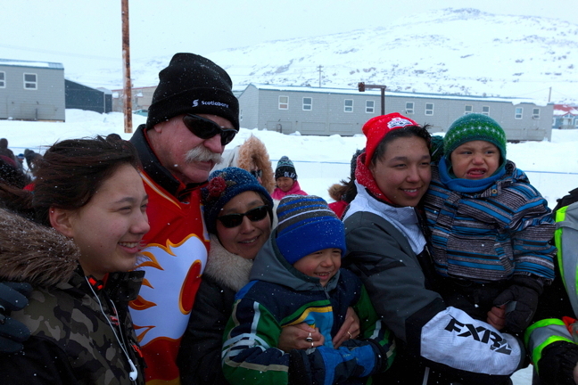 Veteran NHL star Lanny McDonald stands in a sea of fans in Cape Dorset during a visit with the Stanley Cup April 27. McDonald and Canadian Women's Hockey League player Natalie Spooner have joined a Stanley Cup entourage for a tour of eight Nunavut communties this spring. The tour, sponsored by Scotiabank, Project North, Canadian Tire Jumpstart Charities and First Air, are dropping off bags of hockey equipment in each community to give away to local kids. The tour was hoping to stop in Gjoa Haven and Resolute Friday and then finish up in Hall Beach and Qikiqtarjuaq April 29. (PHOTO BY ERIC LANGDON)