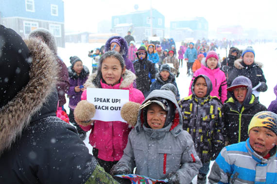 Speak up! Reach out, reads this girl's sign. Puvirnituq youth took part in a Walk for Love and Respect April 28 in the Nunavik community. The event, coordinated by Nunavik's Pivallianiq program, gathered youth from both Iguarsivik and Ikaarvik schools, community organizations and leaders. Organizers said the walk was to demonstrate that the community is stronger when its members come together to show a united front against issues like bullying, abuse and suicide. (PHOTO COURTESY OF PIVALLIANIQ)