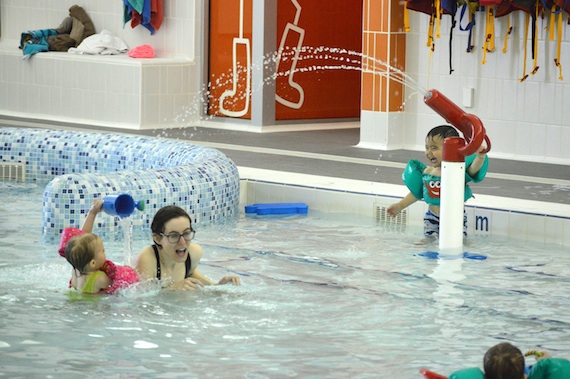 Got you! Parents and tots frolic in the Aquatic Centre's leisure pool during the Friday morning swim time. To encourage more participation, the Iqaluit Parents and Tots Association is offering free taxi vouchers and free swim-diapers to those who want to join in the fun. (PHOTO BY STEVE DUCHARME)