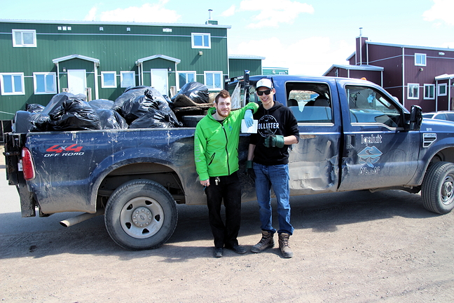 Vincent Hebert, left, and Max Shoo are off to the dump with a load of litter, after an Iqaluit community clean up June 16.