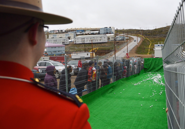 Iqalungmiut strain to see whether their ball will drop into the hole first in the annual Nunavut Day golf ball drop held by Habitat for Humanity. There were two ball drops with each winner receiving $10,000. 