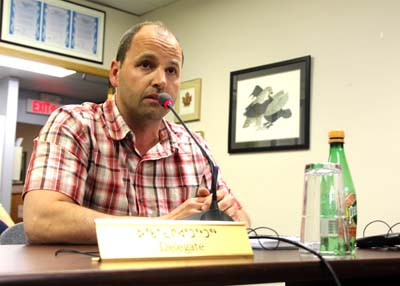 The City of Iqaluit's roads manager Cameron DeLong explains summer plans to resurface Apex Road at a July 25 council meeting. (PHOTO BY BETH BROWN)
