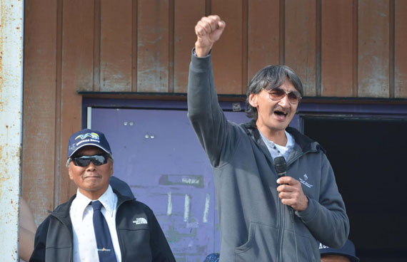 Jerry Natanine speaks to community members in Clyde River at an Aug. 1 rally to celebrate last week's Supreme Court of Canada decision, with Clyde River mayor James Qillaq by his side. On July 26, the court overturned the National Energy Board’s June 2014 authorization of a five-year seismic testing project in the waters of Baffin Bay and Davis Strait, east of Baffin Island. Natanine, one of the appellants in the case, quickly became the face of Clyde River's fight and received a rousing welcome when he returned home from Ottawa earlier this week. (PHOTO BY JACKORASEE IQAQRIALU)