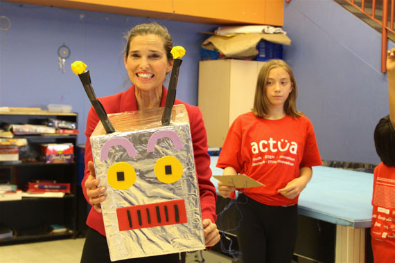 Sophia Mulak, 11, helps Science Minister Kirsty Duncan get through a coding exercise with this robot during Duncan's visit to Iqaluit July 21. (PHOTO BY BETH BROWN)