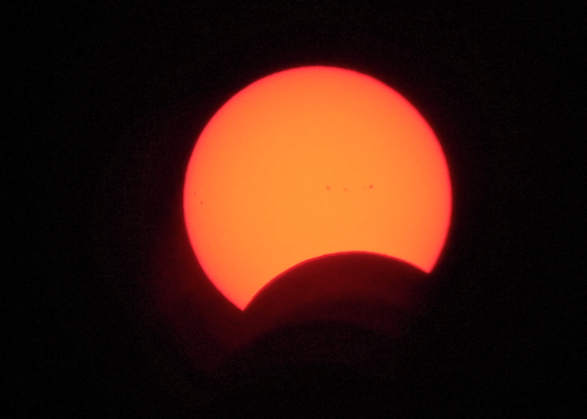 The solar eclipse at maximum in Nunavut, at around 2:20 on Aug. 21, as seen from Iqaluit. People around North America took time out after lunch yesterday to don special glasses or use cameras to watch as the moon passed between Earth and sun. The eclipse was visible in its totality over a band of 14 American states including the first total eclipse for the day in Oregon, at around 9:05 a.m., and it's final one in South Carolina, at 2:48 p.m. According to NASA's website, the longest duration of total eclipse was near Carbondale, Illinois, where the sun was blocked out for two minutes and 40 seconds. (PHOTO BY FRANK REARDON)