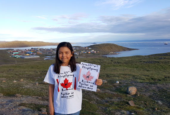 Karena Watson, 12, of Apex, shows off the t-shirt she designed earlier this year for Canada’s 150th anniversary. The shirt reads Piliriqatigiiniq or “Together we achieve more” in Inuktitut, around the image of a traditional Inuit dog team and caribou inside a Canadian flag. Watson was commissioned to come up with the design for Treasures, a store in Stratford, Ont., whose owners wanted to offer a unique, Indigenous creation to commemorate the country’s anniversary. All proceeds from the sale of the t-shirts will be donated to the rebuilding of Kugaaruk’s Kugaardjuq school, which was destroyed in a March 2017 fire. You can order your own shirt by emailing Treasures at jc_treasures@hotmail.com. (PHOTO COURTESY OF A. WATSON)