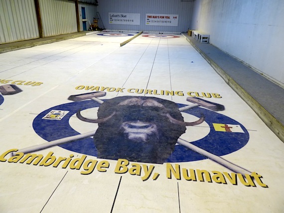 The cover on the earth floor, which used to be flooded with water, features this image of muskox or ovayok, which was the name of the now-defunct curling club in Cambridge Bay. (PHOTO BY JANE GEORGE)
