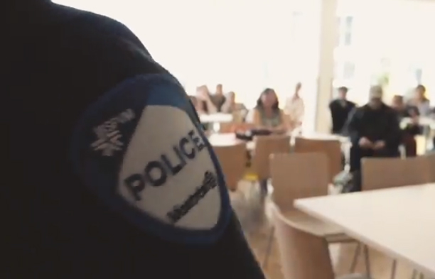 A SPVM officer is pictured in a new video speaking to visitors at the Ullivik patient centre in Montreal, which hosts Nunavimmiut patients who require specialized care in the city. 