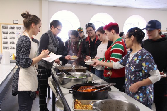 Students line up for lunch at Iqaluit's Inuksuk High School on Dec. 7. The new accessible lunch program is making healthy food a priority for students. 
(PHOTOS BY BETH BROWN)
