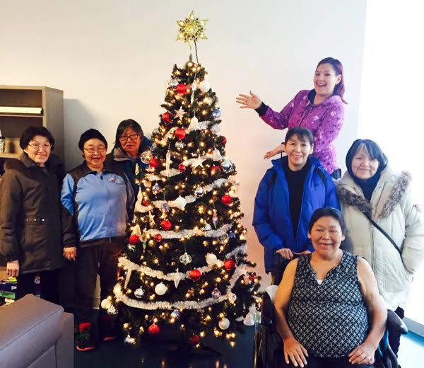 Staff, patients and escorts finish decorating the Christmas tree on Saturday, Dec. 2 at Ullivik, the Montreal residence that hosts Nunavimmiut who are visiting the city for health care reasons. This month marks Ullivik's one-year anniversary in its new Dorval location. (PHOTO COURTESY OF JEANNIE TUKKIAPIK)