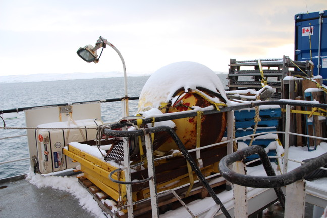 This snow-covered contraption is the top half of an underwater float used to house an autonomous oceanographic sonar that was recovered this summer by the Canadian Coast Guard in Cardigan Strait near Devon Island. The instrument had been missing for 10 years. (PHOTO BY BETH BROWN)