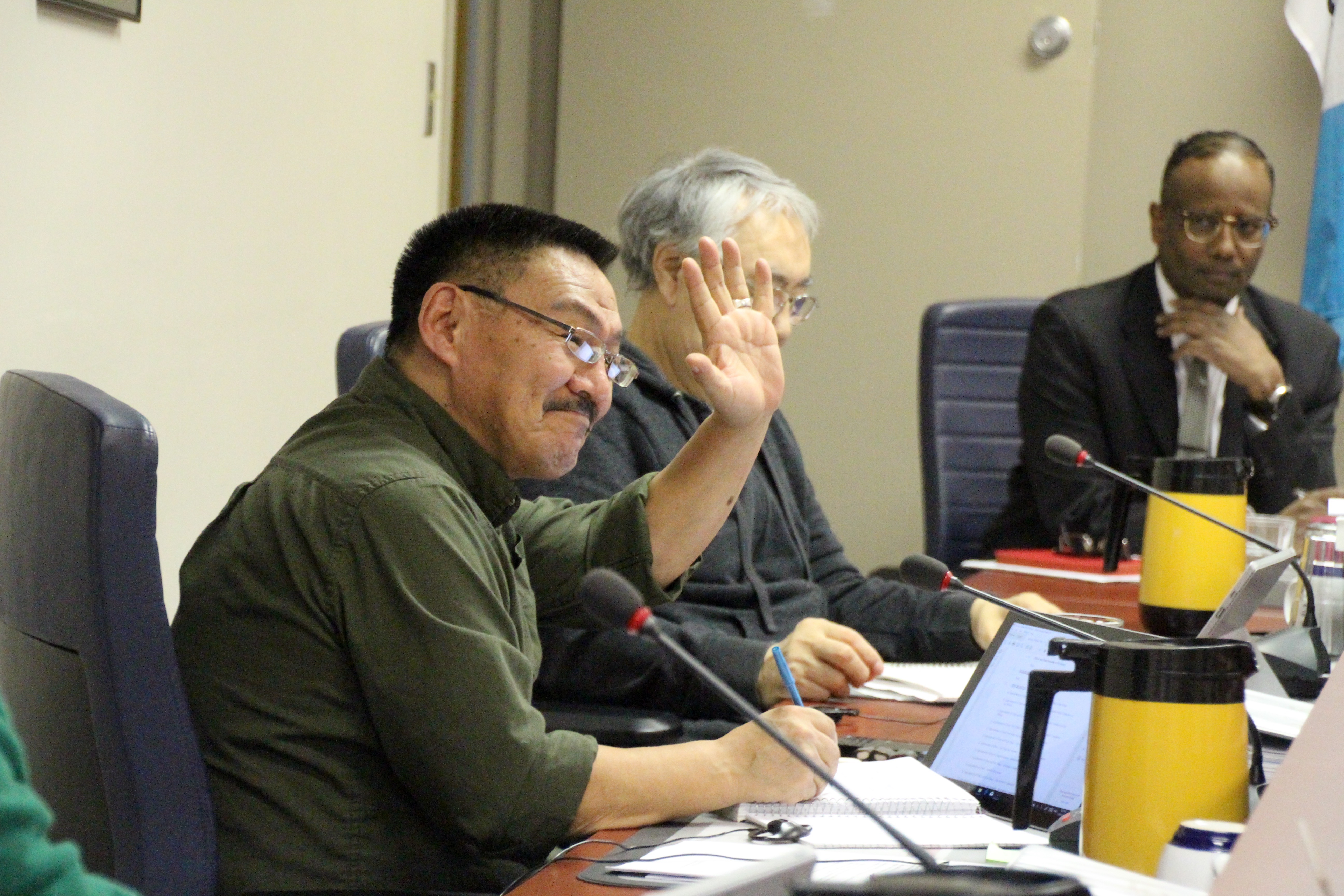 Iqaluit city councillor Joanasie Akumalik waves across the chamber to councillor Jason Rochon, after beating him five to one in a run-off vote, when the two men were both nominated to serve as a member on the city’s economic development committee for 2018. “I felt as if I was doing an auction,” Mayor Madeleine Redfern said, after calling out the annual appointments of chair, vice chair and member positions on city committees, during the first council meeting of the year, Jan. 9. (PHOTO BY BETH BROWN)