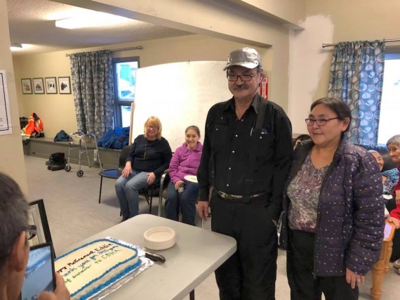 Eddie Mala, who worked for the Cambridge Bay Housing Association for nearly 35 years, is honoured Feb. 9 at a CBHA retirement party in Cambridge Bay. Among other gifts, Mala received a cake, whose message wished him a good retirement, and a certificate recognizing his long years of service. (PHOTO COURTESY OF THE CBHA)