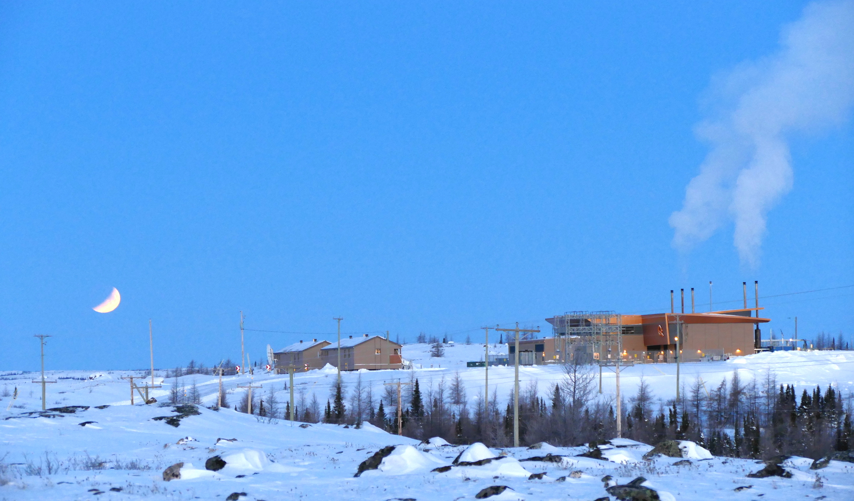 Photographer Allen Gordon caught the eclipse of last month's super moon as it was going over the horizon on the morning of Jan. 31 over Kujjuaq. The large building belongs to Hydro Quebec. (PHOTO BY ALLEN GORDON)