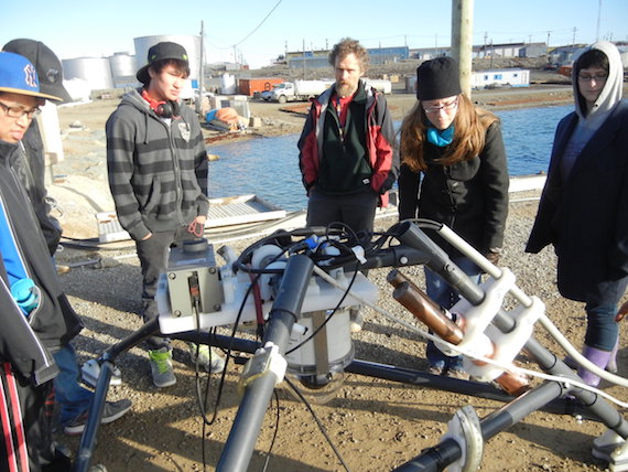 Science in action: students from Kiilinik High School in Cambridge Bay learn about the University of Victoria's underwater observatory before the observatory was lowered into the water near the community dock. (PHOTO BY JANE GEORGE)