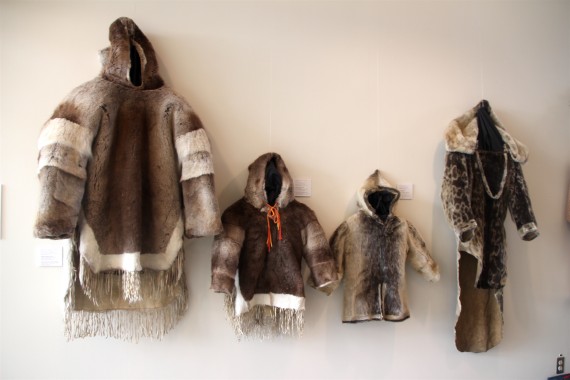 The foyer of Nunavut's legislature is decked out this week with a display of Inuit parkas, new and old. Besides these caribou and sealskin coats fit for the whole family, the collection showcases a floor-length sealskin trench coat with polar bear claw toggles, an embroidered wool duffel parka, a cotton-covered duffel amauti made in Pangnirtung, a Western-style Mother Hubbard sunburst parka with a patterned cotton cover, and some fashion-forward pieces like a purple Arctic Goddess jacket by designer Rannva Simonsen and a seal-and-leather-mix Arctic Allure jacket by designer Victoria Kakutinniq. (PHOTO BY BETH BROWN)