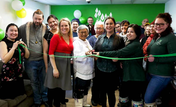 Qarjuit Youth Council president Alicia Aragutak, centre, cuts a ribbon at the council's new head office last month with elder appointee Louisa Cookie-Brown. Qarjuit's new office is located in Kuujjuaq along Airport Road, in the former Nunavik Creations boutique. The office is open Monday to Friday. (PHOTO BY TUMIIT MEDIA/QARJUIT)