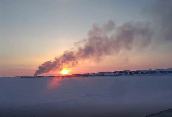 Inukjuak's former weather station, located in the centre of the Nunavik community along Hudson Bay, was destroyed in an April 9 fire. John Myna photographed the smoke from the blaze from across the Inukjuak river, just south of the community of 1,800. It's unclear how the fire started, but it won't affect weather data; Inukjuak's newer and operating weather station is located by its airport. (PHOTO BY JOHN MYNA)