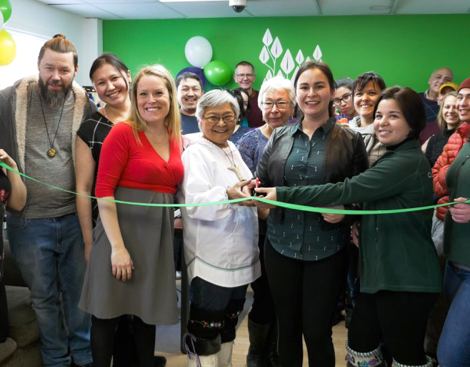 Qarjuit Youth Council president Alicia Aragutak and elder appointee Louisa Cookie-Brown, centre, cut the ribbon at the youth council’s new office opening earlier this year. The two will help lead a two-day retreat for youth and elders in Kangiqsujuaq April 17-18. (PHOTO COURTESY OF QARJUIT)
