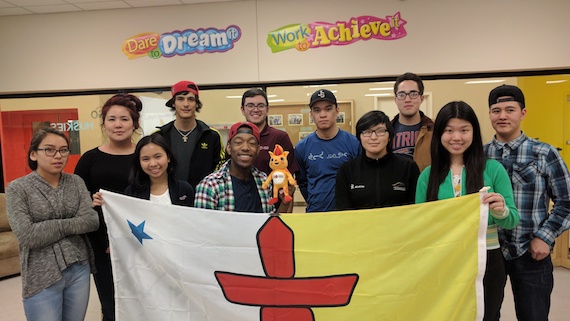 Nunavut and Northwest Territories youth ambassadors pose with a Nunavut flag on their way to help with the 2017 Canada Games in Winnipeg. The Canada Games are among the events supported by the Youth Ambassador Program. (PHOTO COURTESY OF THE CANADA GAMES)