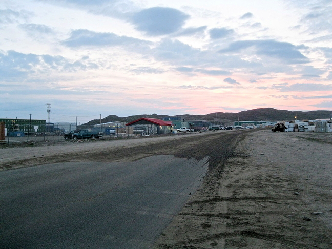 A worn-out stretch of Iqaluit's Federal Road, which will be repaved this summer. Work to prepare the road will start next week and repaving will start in July. The road will be reduced to one lane for the duration of the project. (FILE PHOTO)