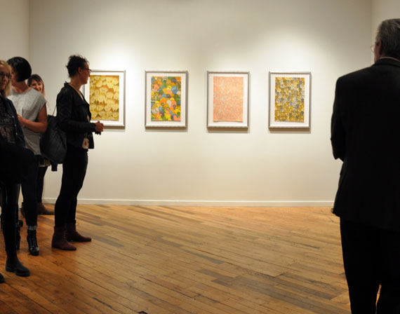 Art lovers gather around a series of prints by Cape Dorset artist Shuvinai Ashoona on exhibit at Open Studio in Toronto April 26. Dorset Fine Arts hosted the show, A Multitude of Infinities, which featured four of Ashoona's eye-catching wildlife prints: Seals, Octopuses, Clams and Walruses. (PHOTO BY SARAH ROGERS)