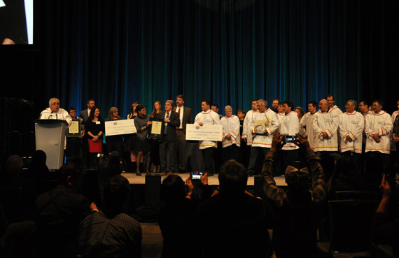 Members of Unaaq Men’s Association of Inukjuak stand on stage to receive their $500,000 Arctic Inspiration Prize win last year. (FILE PHOTO)
