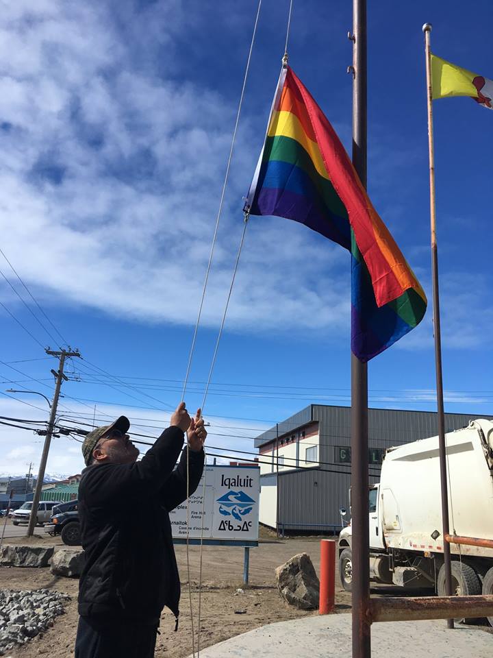 City of Iqaluit facility worker Mike Giles raises the pride flag at Iqaluit city hall Thursday morning, June 28. City council voted at its last meeting to raise the flag for Pride Month, June, as a way to acknowledge the presence and rights of the lesbian, gay, bisexual, transgender and queer community. (PHOTO COURTESY OF THE CITY OF IQALUIT)