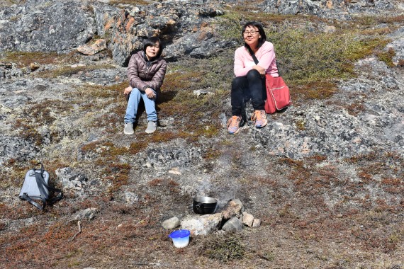 Pitsulala Lyta, right, has been making traditional heather fires on the land behind the women's shelter in Apex for years with other Inuit women to make tea. She said when the shelter staff and fire department told her this summer that they were not allowed to make fires without a permit, she reached out to Mayor Madeleine Redfern, who clarified that Lyta could make her traditional fires without a permit. (PHOTO BY COURTNEY EDGAR)