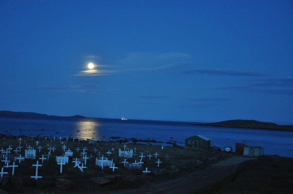 The full moon illuminates Iqaluit's municipal cemetery on July 28. The lights of a passing Coast Guard ship can also be seen. (PHOTO BY SARAH ROGERS) 