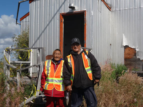 Elder Mary Anowtalik, the only surviving Ahiarmiut who can recall the relocations from Ennadai Lake, stands in from of the weather station there with her son Paul E. Anowtalik in August 2013. Ahiarmiut hope to see a memorial eventually set up on the site. (FILE PHOTO)