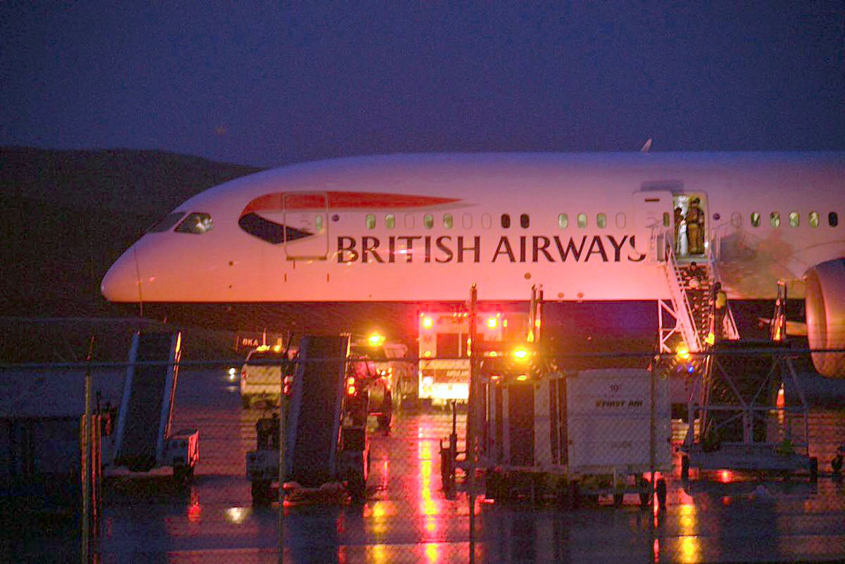 An Iqaluit firefighter can be seen standing at the door of a British Airways jet on the evening of Wednesday, Sept. 12, about an hour and a half after the aircraft made an emergency landing in Iqaluit. (PHOTO BY FRANK REARDON)