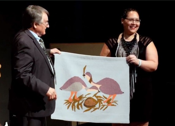 Nunavut Tunngavik Inc. president Aluki Kotierk presents a tapestry by Pangnirtung artists Annie Kilabuk and Anna Etoangat to Makivik Corp. president Charlie Watt on Wednesday, Nov. 14, at Makivik's 40th anniversary celebration in Kuujjuaq. (PHOTO COURTESY OF MAKIVIK)
