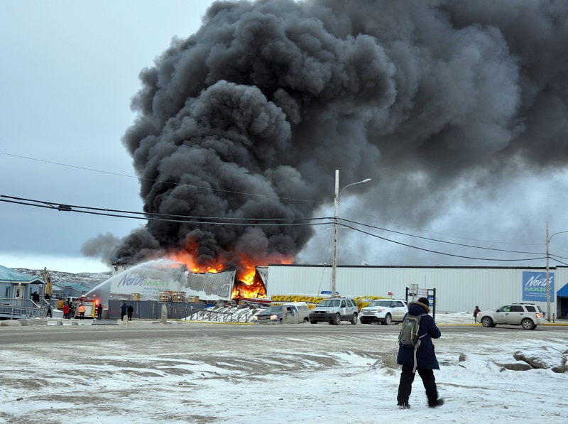 Police continue to seek the help of the public to find at least one more suspect connected to five fires started around Iqaluit late on Nov. 7 and early on Nov. 8, the Iqaluit RCMP said on Wednesday. These include the fire that destroyed the Northmart warehouse. Police arrested two youth in connection to these fires; one was later released and the other teen has now been charged with arson with disregard for life. Police now say that a sixth vehicle fire first reported to be connected to the others has now been deemed