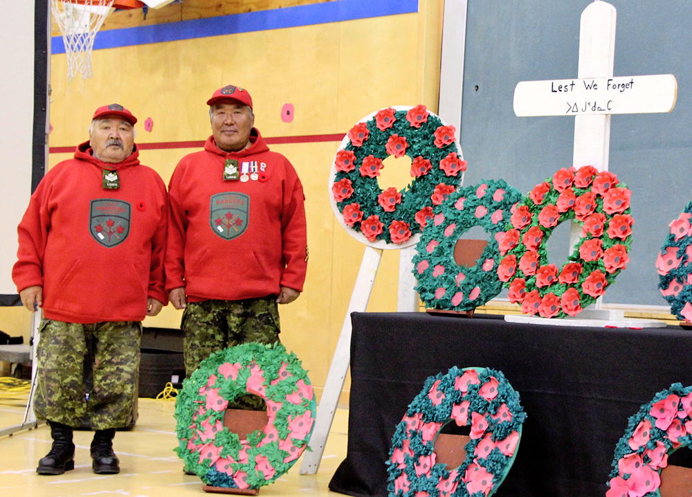 Nunavut remembers: Canadian Ranger Master Cpl. Okookoo Quaraq and Ranger Sgt. Titus Allooloo take part in a Remembrance Day ceremony at Nassivik High School on Thursday, Nov. 8, in Pond Inlet. (PHOTO BY BETH BROWN)