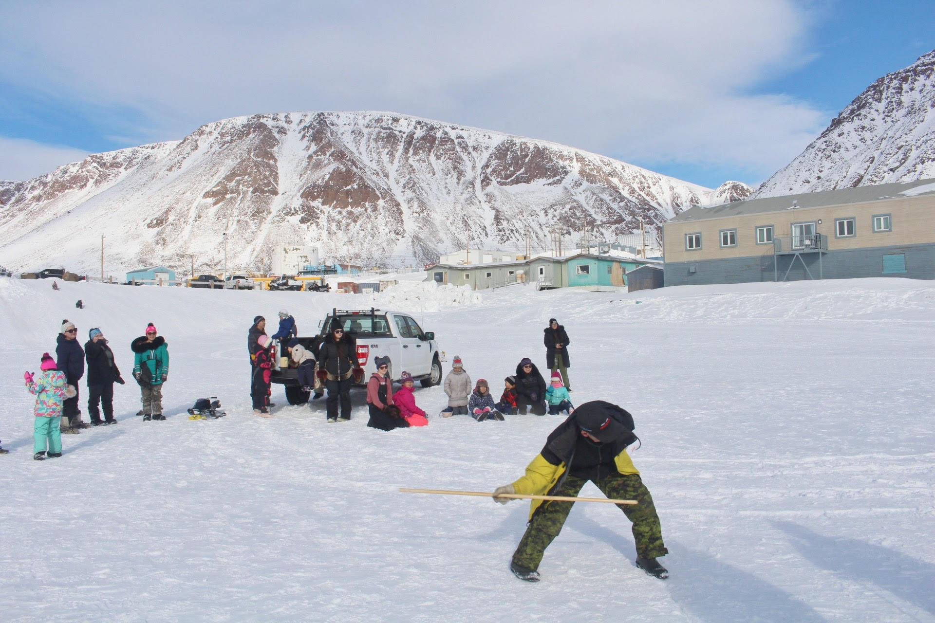 Jarloo Kiguktak throws a broomstick Monday during Grise Fiord’s Easter games. At least 30 people in Nunavut’s smallest and northernmost community gathered outside the hamlet office to take part in the games, which also included an Easter egg hunt, bunny hop and egg-on-spoon races. (Photo by Jeff Pelletier)