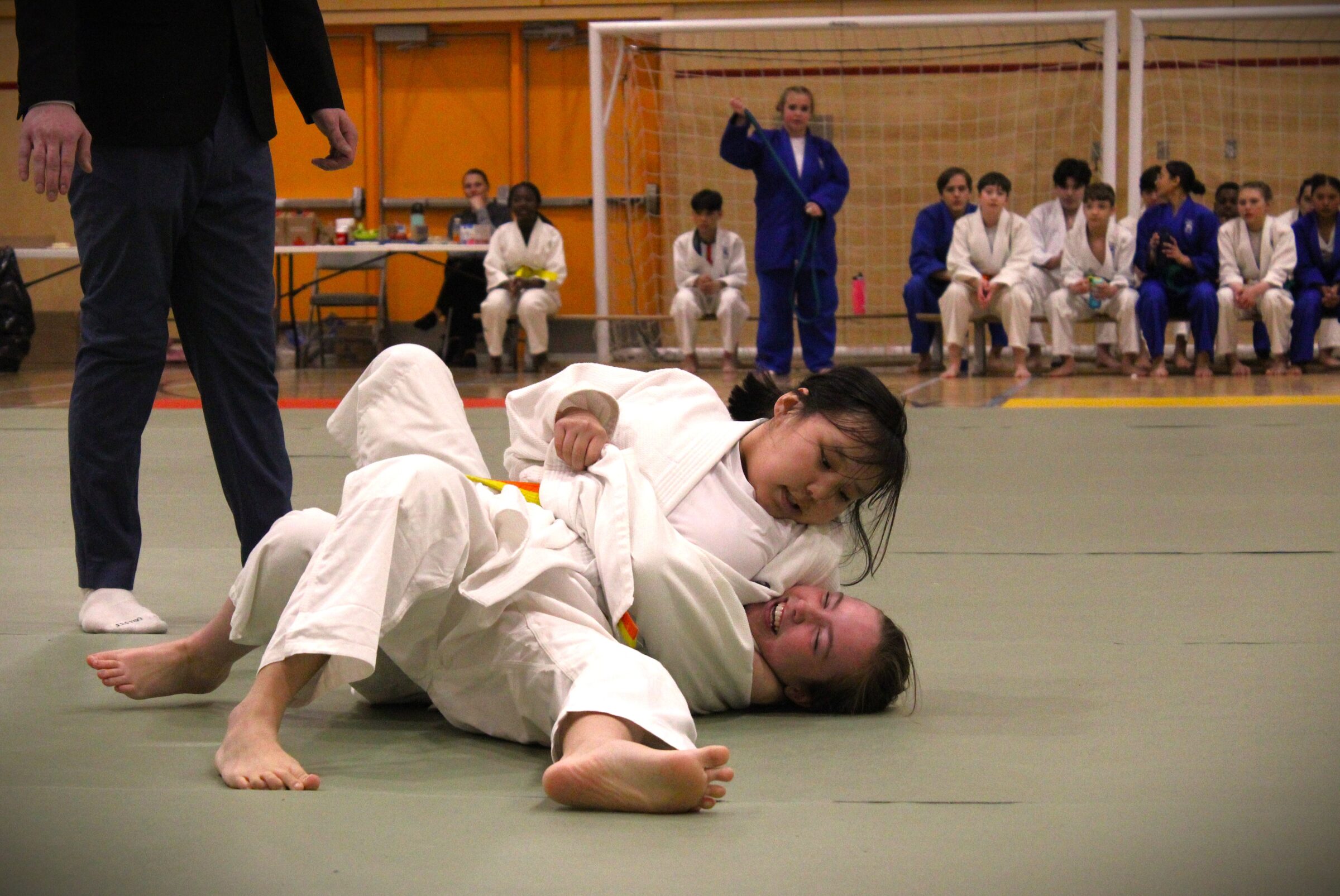 Judo Nunavut members Meeka MacDonald, 12, top, and Charlotte Fewer, 13, compete in the Judo Nunavut year-end tournament, held Saturday in the Aqsarniit Ilinniarvik School gymnasium in Iqaluit. More than 80 competitors in three age categories participated in the event, making it the biggest tournament turnout in the organization’s 21-year history. Registration for the next season will take place in September, said coach Matilda Pinksen. (Photo by Daron Letts)