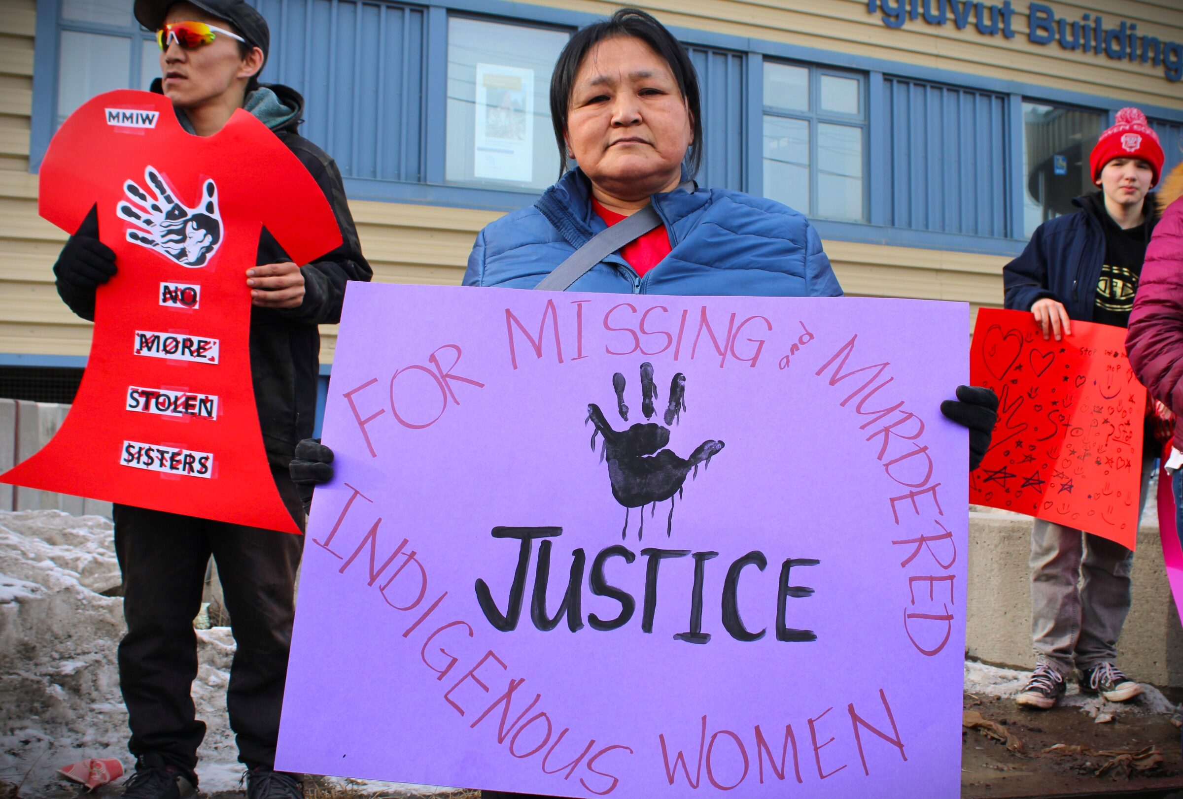Dinah Pikuyak holds a sign demanding justice for missing and murdered Indigenous women at Iqaluit’s Red Dress Day march Monday. Approximately 75 people attended on the May 5 National Day of Awareness for Missing and Murdered Indigenous Women and Girls and Two-Spirit-Plus people. “I’m here on behalf of my niece Savanna who was murdered in Ottawa when she went for a nursing program,” she said. Savanna Pikuyak, 22, was murdered in Ottawa on Sept. 11, 2022, a week after she moved to Ottawa from Sanirajak. (Photo by Daron Letts)